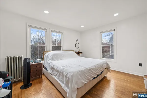 a large bed sitting in a bedroom next to a window