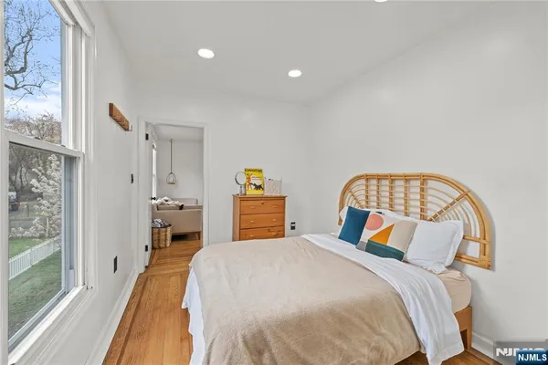 a bedroom with a bed and a wooden floor