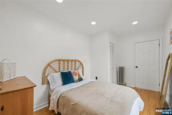 a bedroom with a bed and a mirror