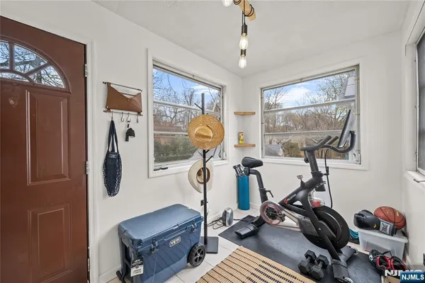 a room with gym equipment and windows