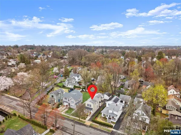 an aerial view of residential houses with city view