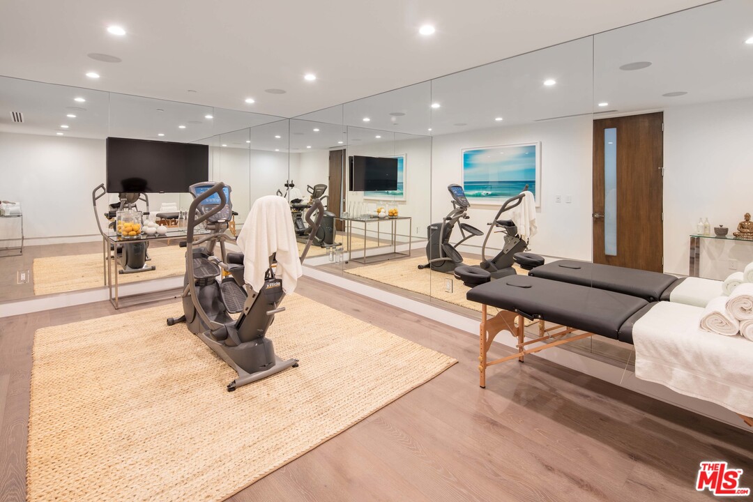 2192 Stradella Road Los Angeles, CA 90077 - Photo 19 of 23 a living room with furniture a flat screen tv and a table