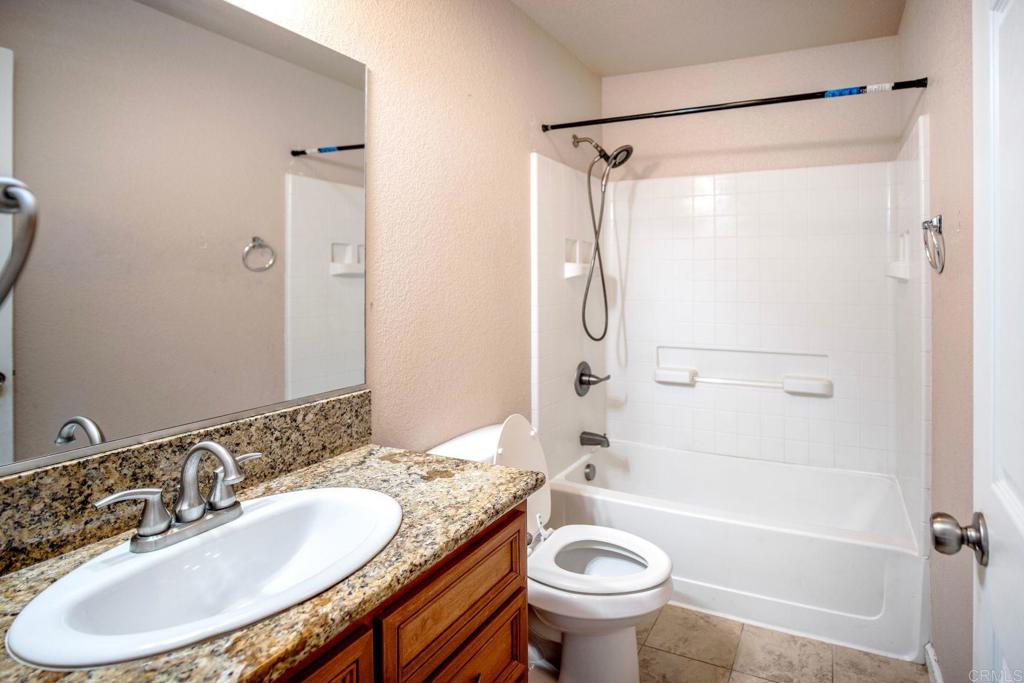 4990 Del Road Loomis, CA 95650 - Photo 11 of 22 a bathroom with a granite countertop sink toilet and shower