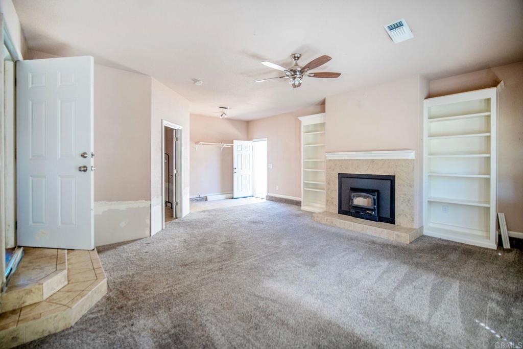 4990 Del Road Loomis, CA 95650 - Photo 9 of 22 a view of an empty room with a fireplace and a window