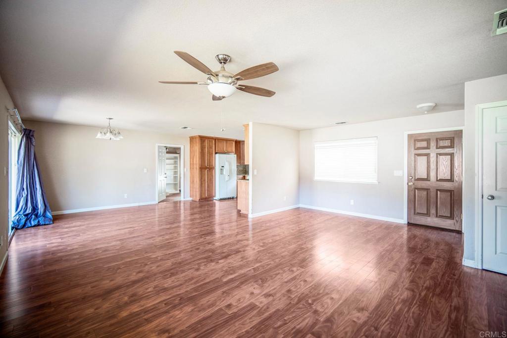 4990 Del Road Loomis, CA 95650 - Photo 10 of 22 a view of a livingroom with wooden floor and a ceiling fan
