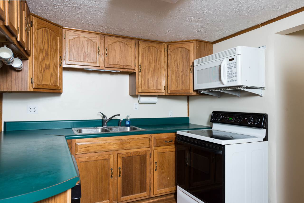 10572 Cook Town Road Bridgewater, VA 22812 - Photo 3 of 24 a kitchen with stainless steel appliances granite countertop a sink stove and microwave