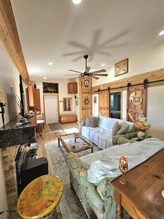 a living room with furniture and wooden floor
