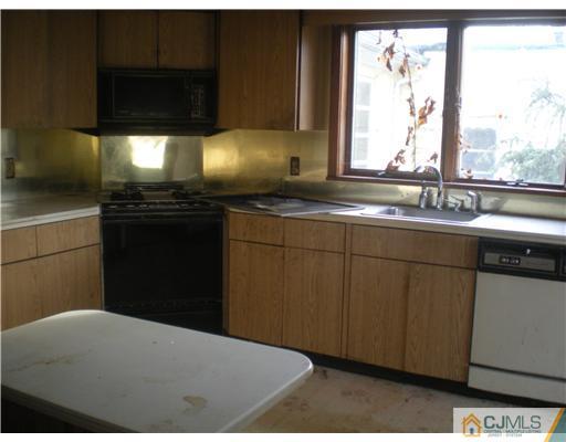 220 Gordon Road Old Bridge, NJ 07747 - Photo 6 of 9 a kitchen with stainless steel appliances a sink a stove and a window