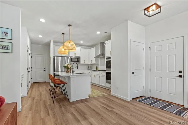 a view of kitchen with dining area window and wooden floor
