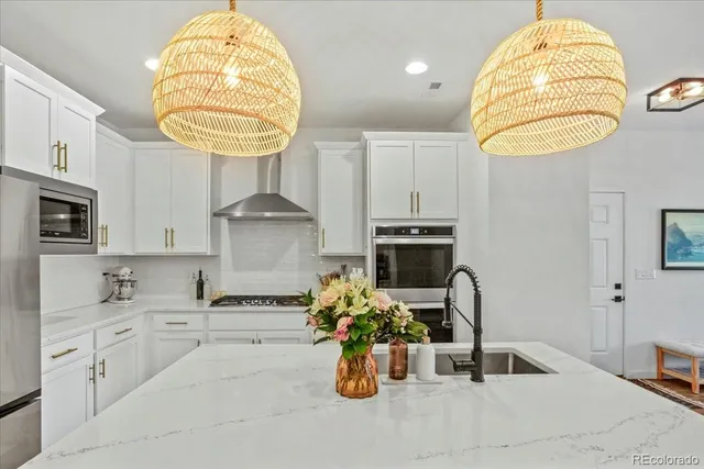 a kitchen with a sink dishwasher and a fireplace