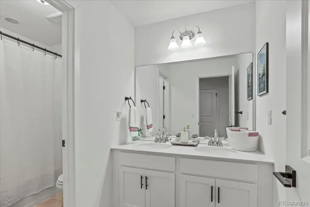 a bathroom with a double vanity sink and a mirror