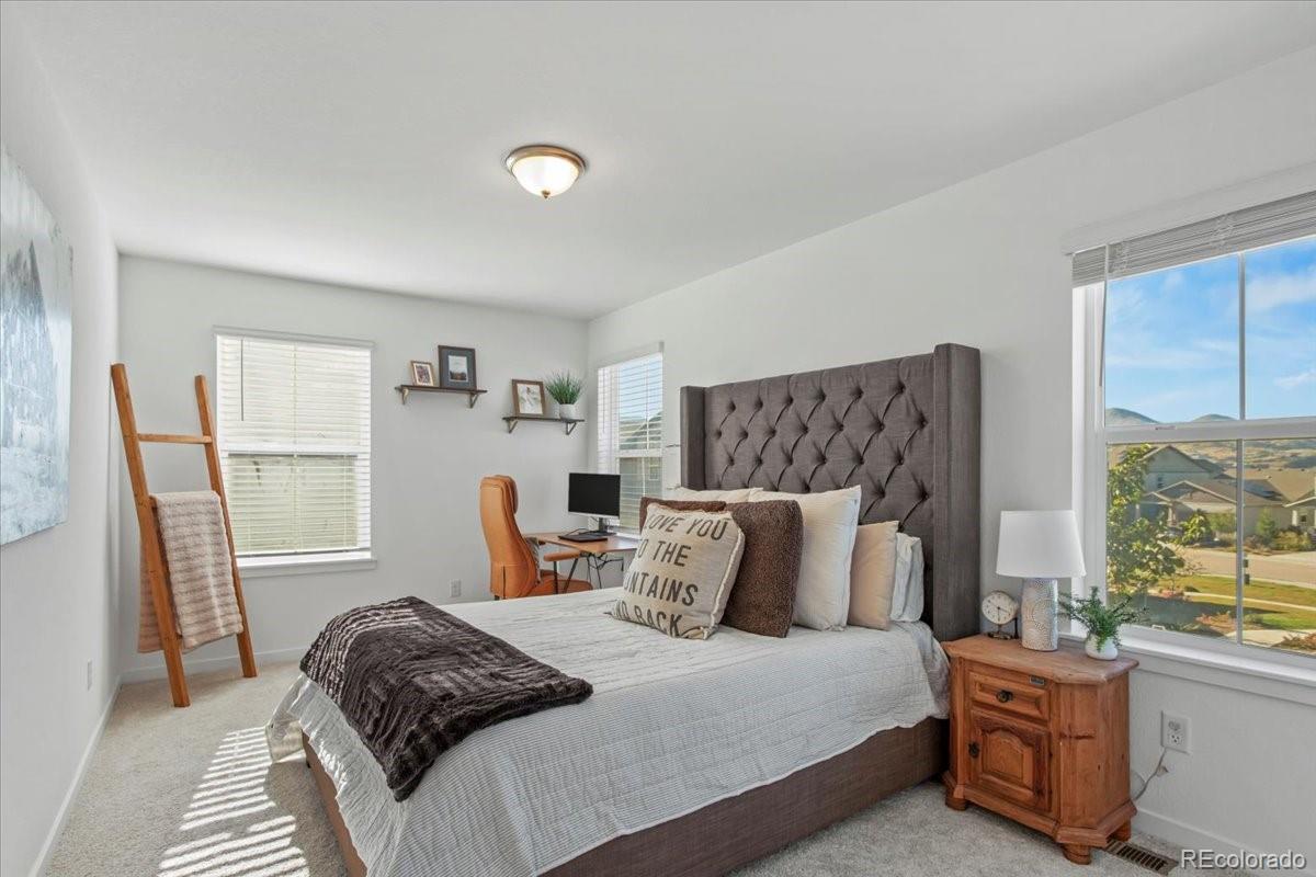 9790 Mount Kataka Point Littleton, CO 80125 - Photo 22 of 32 a bedroom with a bed and a window
