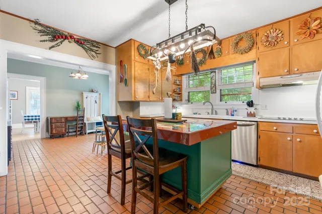 a utility room with granite countertop cabinets and white appliances