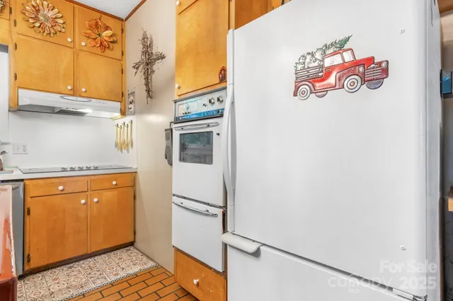 a kitchen with stainless steel appliances cabinets a large window and a sink