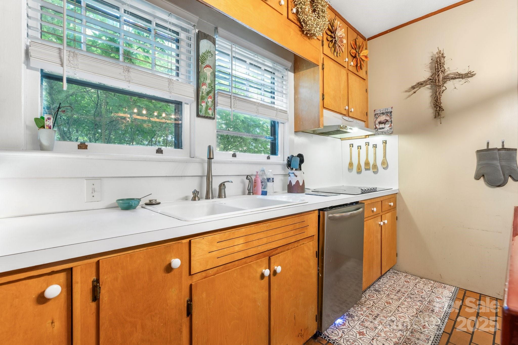 313 East Main Street Morganton, NC 28655 - Photo 15 of 48 a kitchen with stainless steel appliances cabinets a large window and a sink