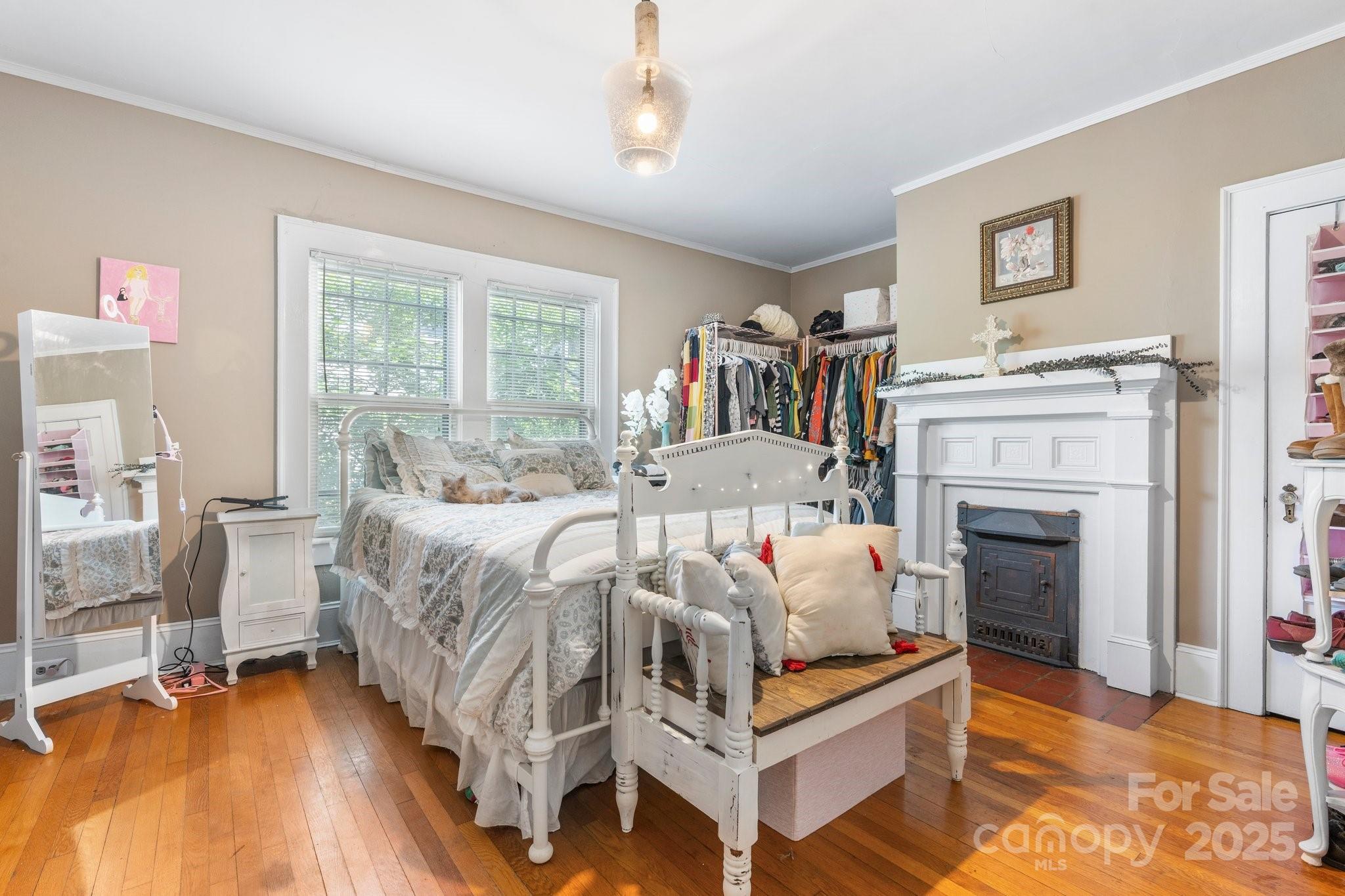 313 East Main Street Morganton, NC 28655 - Photo 17 of 48 a bedroom with a bed and a fireplace