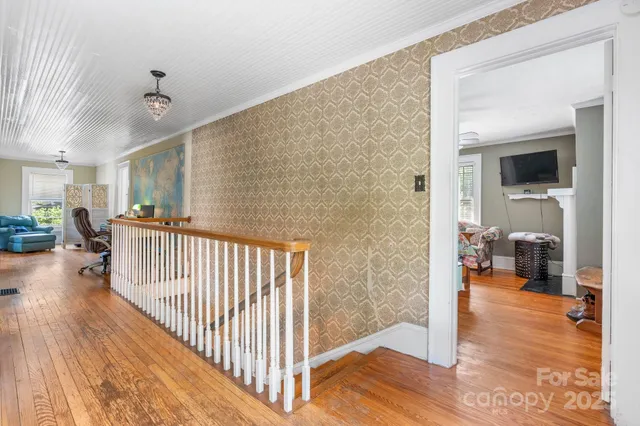 a bedroom with furniture and a flat screen tv