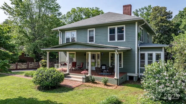a front view of a house with a yard table and chairs