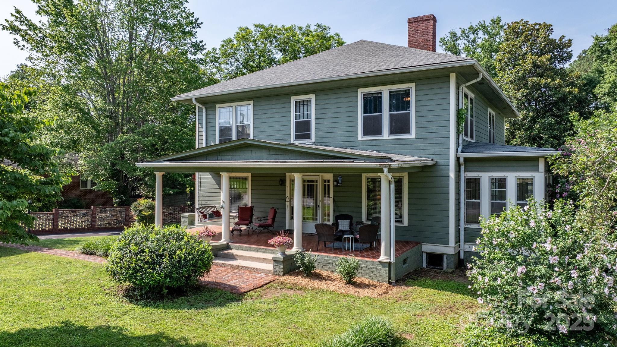 313 East Main Street Morganton, NC 28655 - Photo 2 of 48 a front view of a house with a yard table and chairs