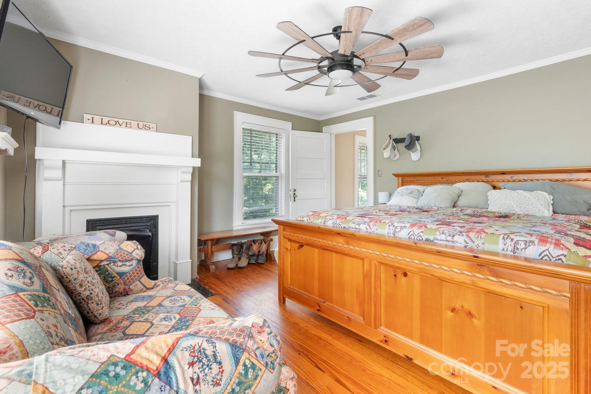 313 East Main Street Morganton, NC 28655 - Photo 22 of 48 a bedroom with a bed and a fireplace