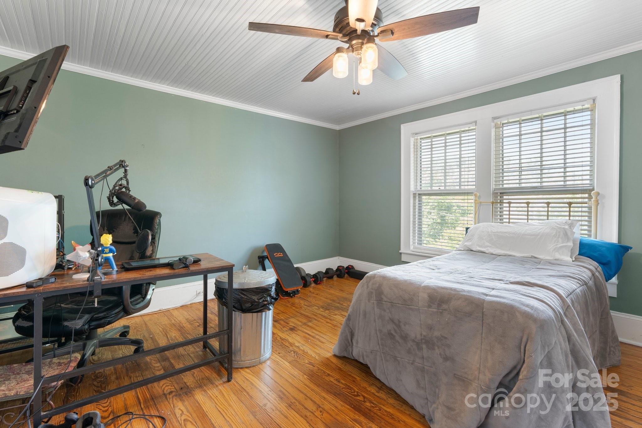 313 East Main Street Morganton, NC 28655 - Photo 26 of 48 a bedroom with a bed and a chandelier
