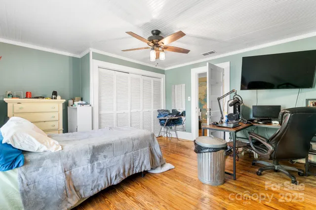a bedroom with furniture and a large window