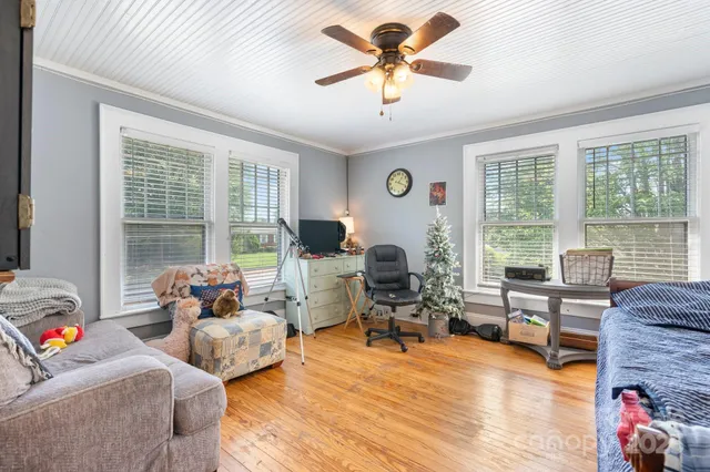 a bed sitting in a spacious bedroom next to a window