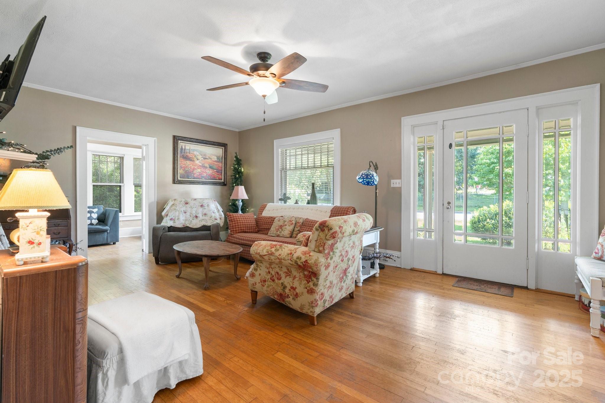 313 East Main Street Morganton, NC 28655 - Photo 4 of 48 a spacious bedroom with a bed couches chair and a large window