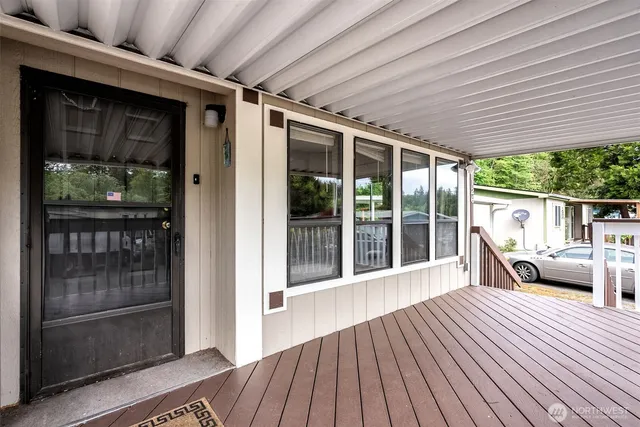 a view of a deck with table and chairs and wooden floor