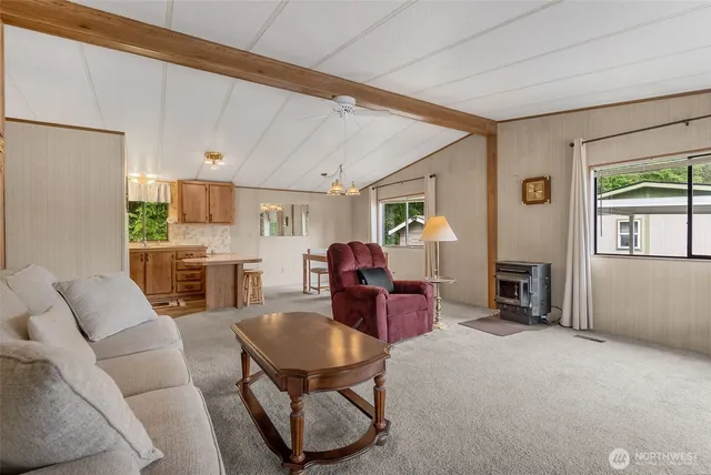a living room with furniture a fireplace and a large window