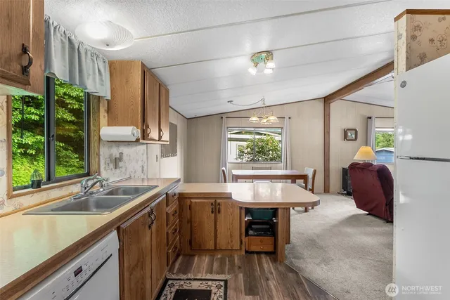 a kitchen with a sink cabinets and window