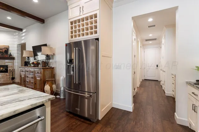 a kitchen with stainless steel appliances a refrigerator and wooden floor