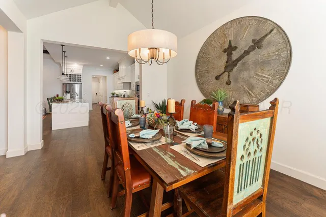 a dining room with furniture and wooden floor