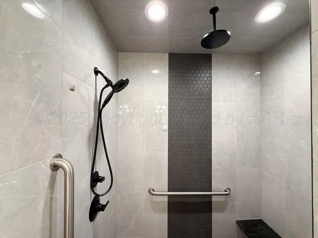 a bathroom with a tub sink and mirror