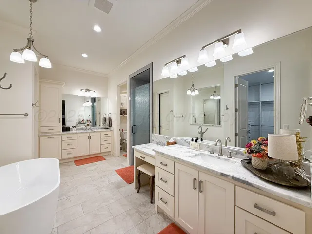 a bathroom with a sink a mirror and a shower