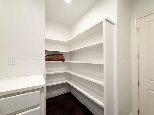 a bedroom with a bed and a lamp on table