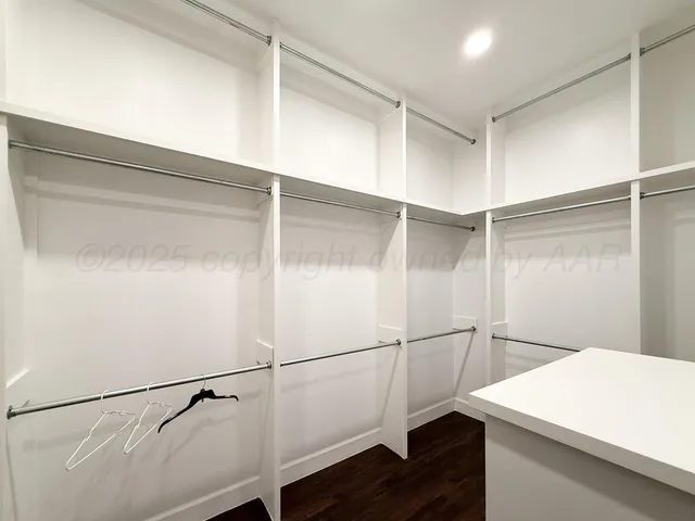 a bathroom with a granite countertop sink a large mirror and a toilet