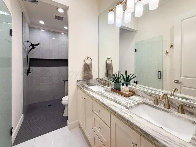 a bedroom with two beds and a desk