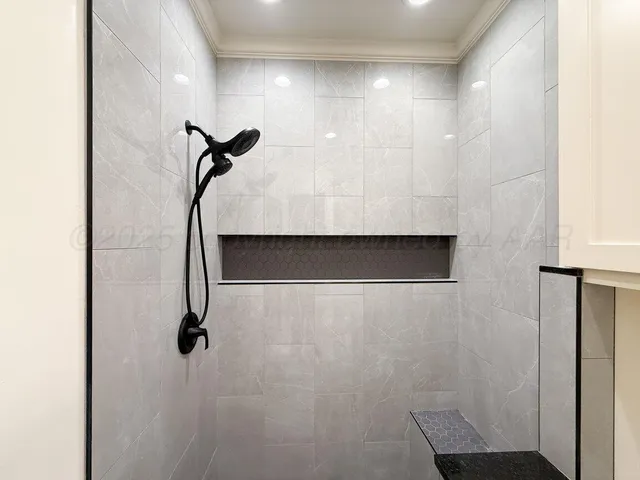 a bathroom with a granite countertop toilet sink and mirror