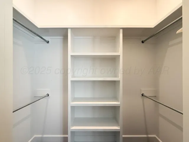 a view of an empty walk in closet