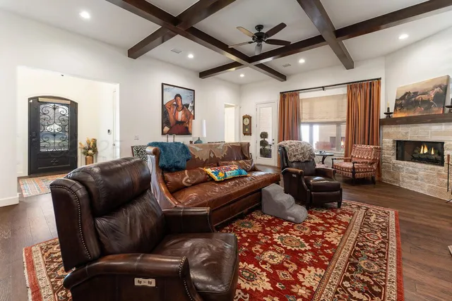 a living room with furniture ceiling fan and a rug