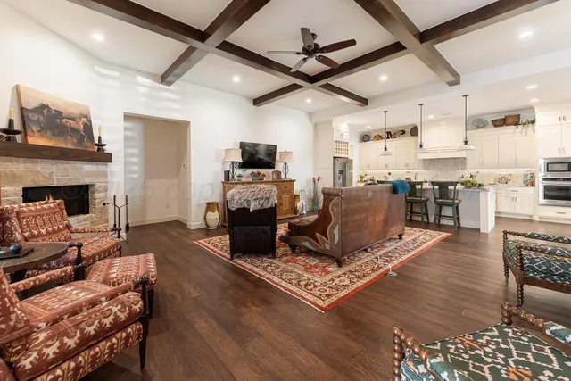 a living room with furniture a fireplace and a flat screen tv