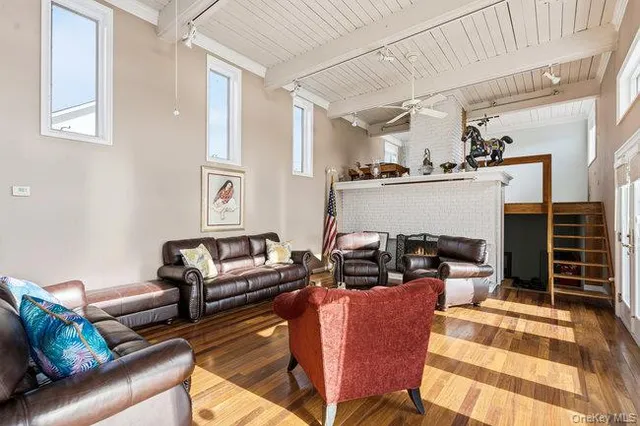 a living room with furniture and a dining table