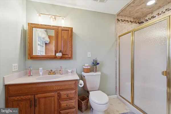 a bathroom with a toilet a sink and a mirror