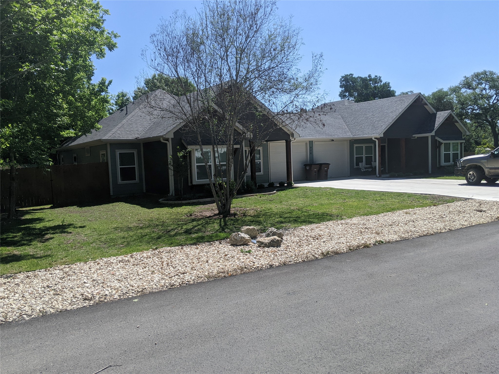 906 Kate Street, Unit A Lockhart, TX 78644 - Photo 10 of 15 Ranch-style house with concrete driveway, an attached garage, and roof with shingles