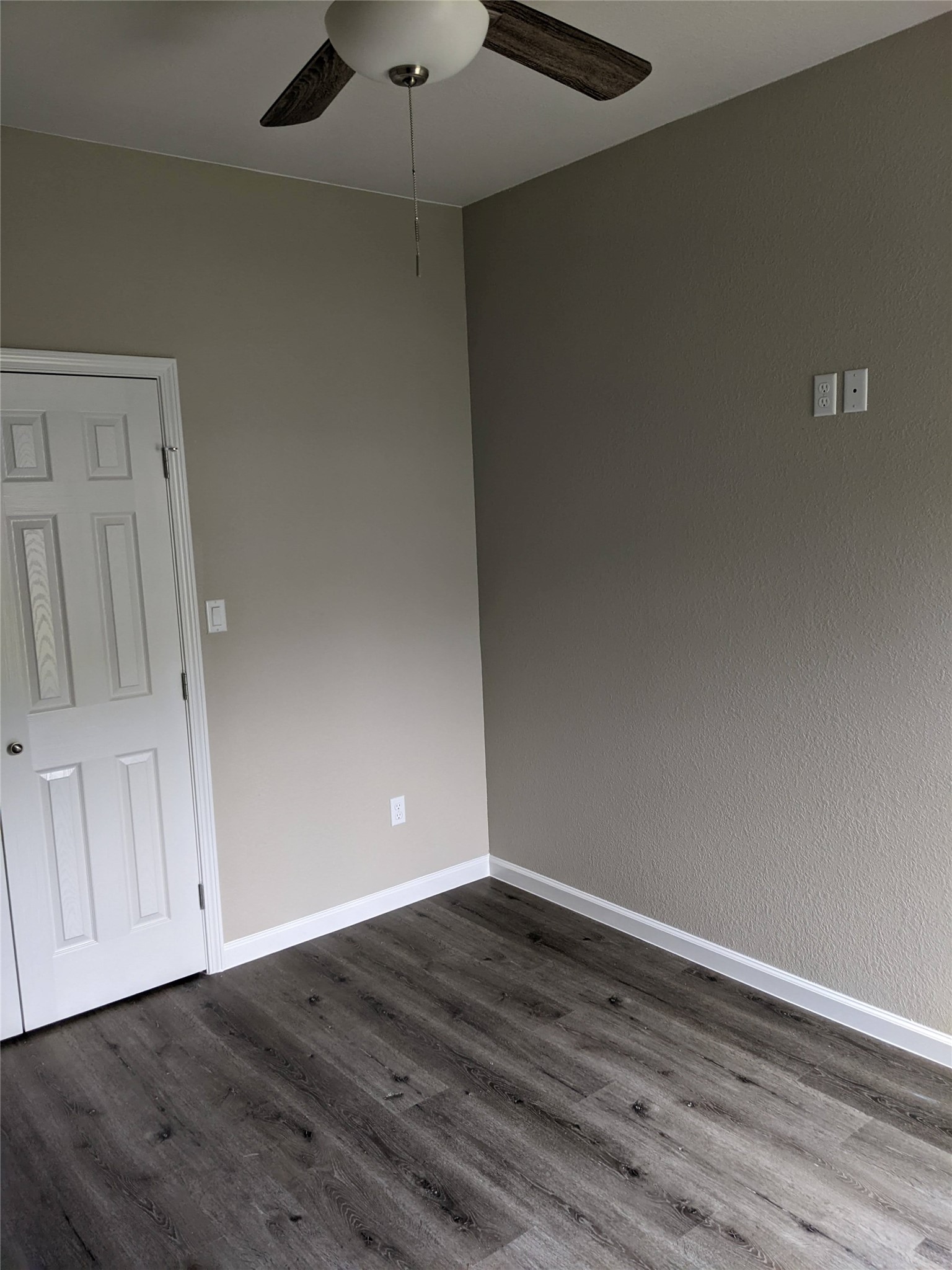 906 Kate Street, Unit A Lockhart, TX 78644 - Photo 5 of 15 Bed room featuring a ceiling fan and dark wood-type vinyl flooring