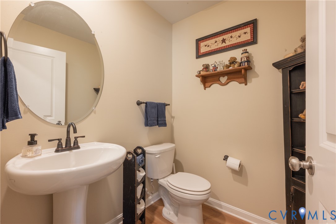17854 Meriwether Lewis Street Ruther Glen, VA 22546 - Photo 18 of 39 Pedestal sink with dark bronze faucet, oval mirror