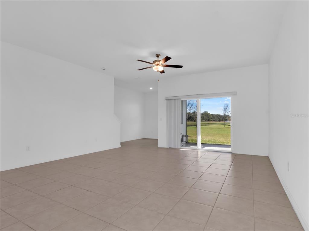 12408 Crystal Jade Way Parrish, FL 34219 - Photo 12 of 51 a view of an empty room with a ceiling fan and window