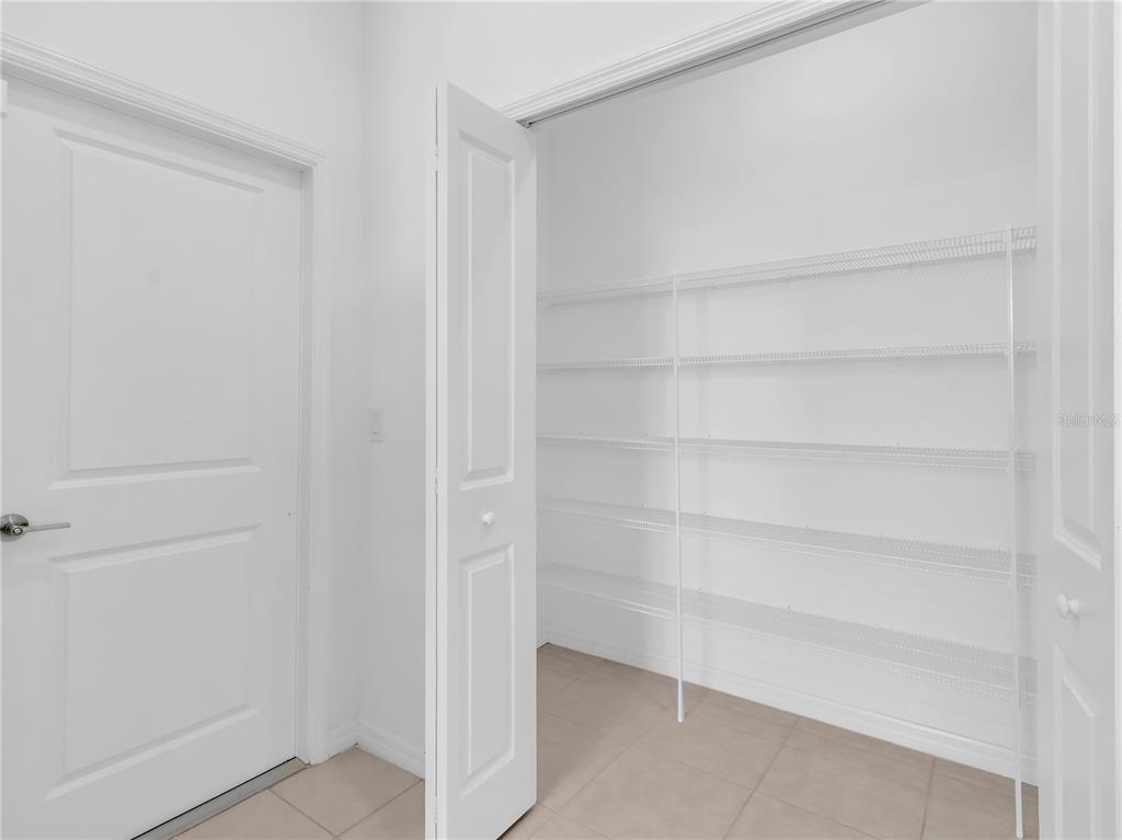 12408 Crystal Jade Way Parrish, FL 34219 - Photo 21 of 51 a view of an empty walk in closet