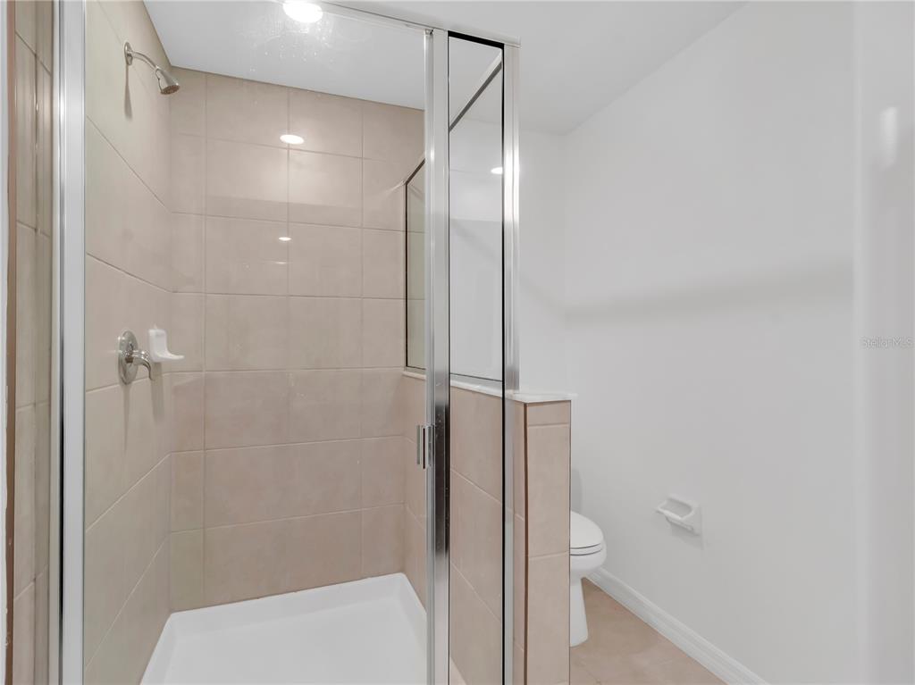 12408 Crystal Jade Way Parrish, FL 34219 - Photo 27 of 51 a bathroom with a shower and toilet
